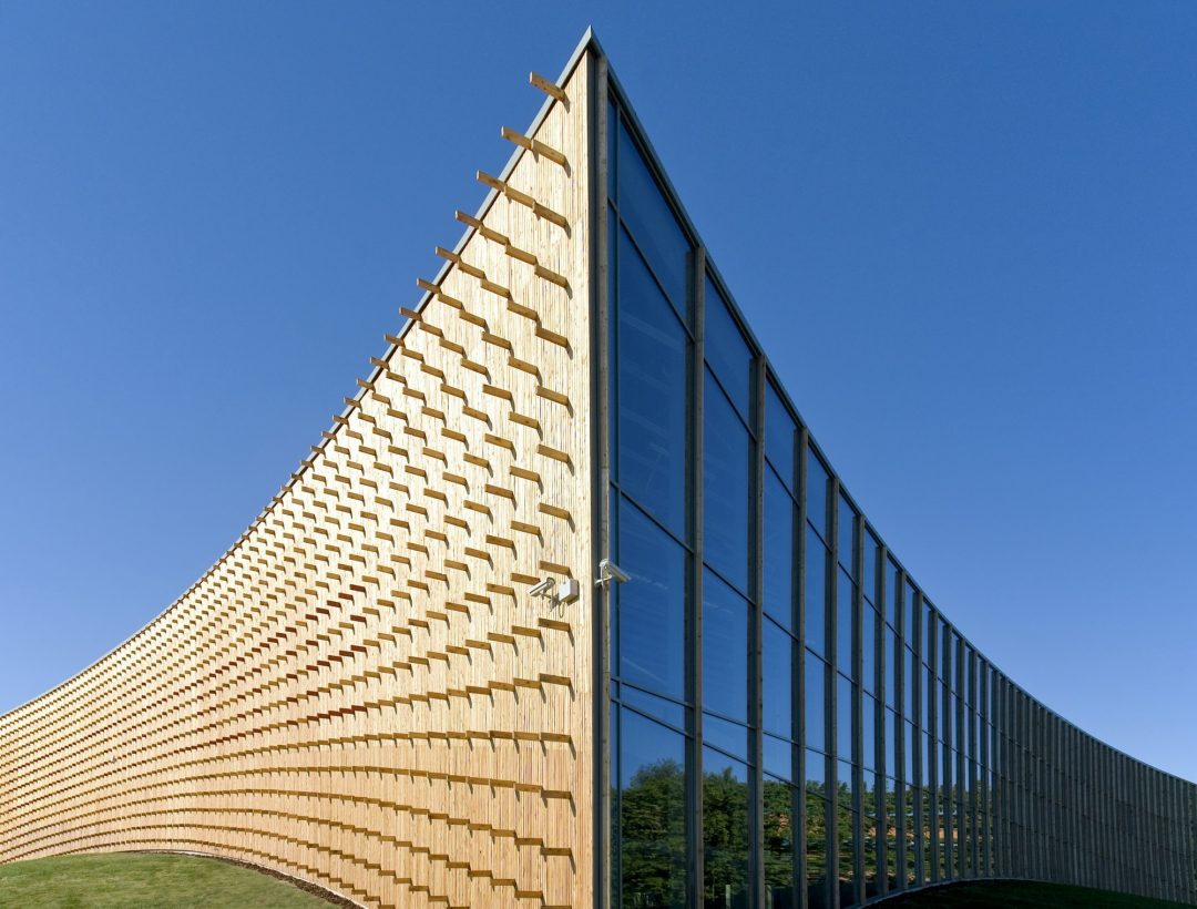modern university buildings wooden beams projecting from a curved wood cladding